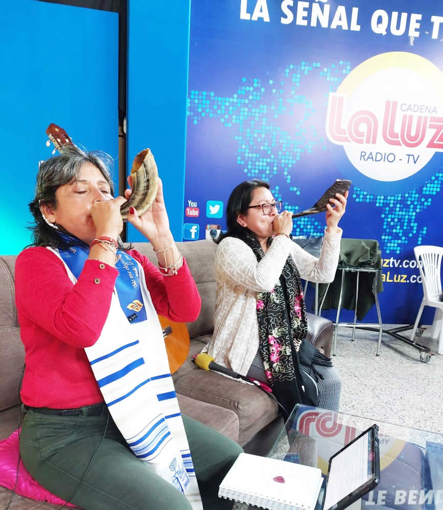 Two women blowing shofar