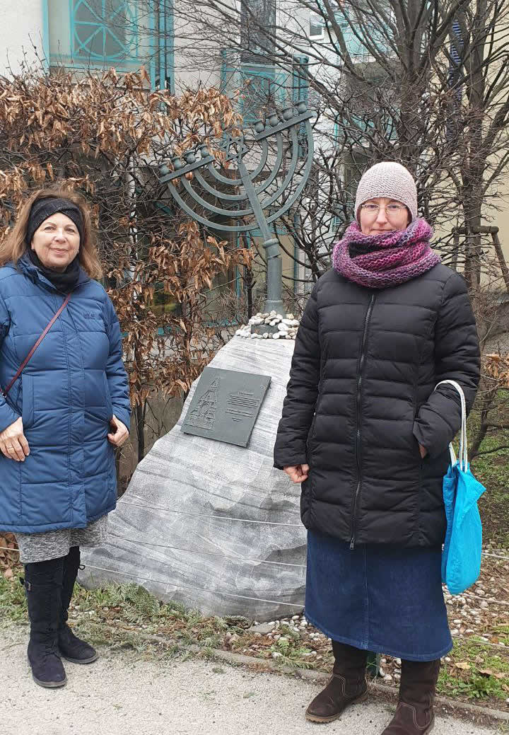 Two women by Jewish monument