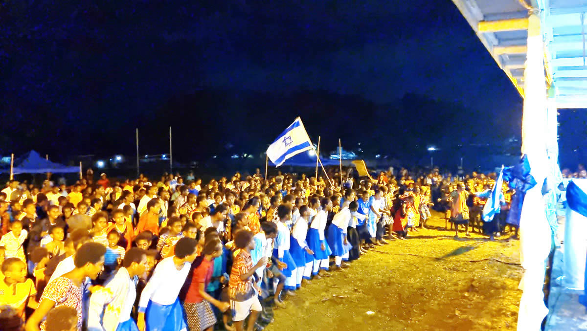 People from PNG with Israeli symbols in front of the stage