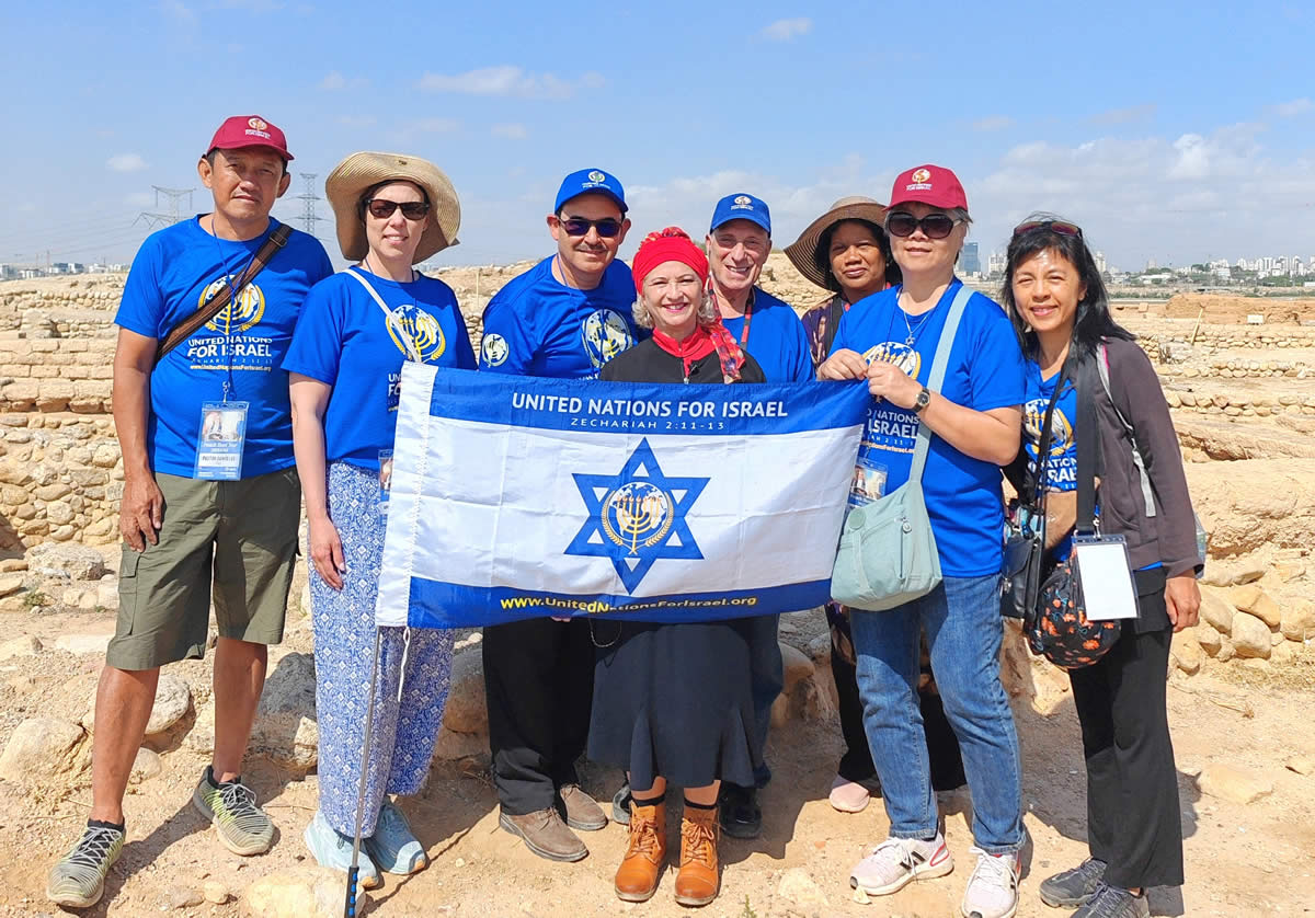 AB and Israel tour participants holding UNIFY flag