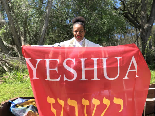Woman from Australia holding Yeshua flag