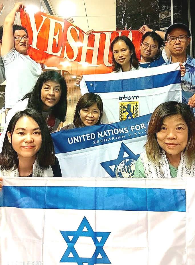 Group of people from Hong Kong holding UNIFY and Israeli flags