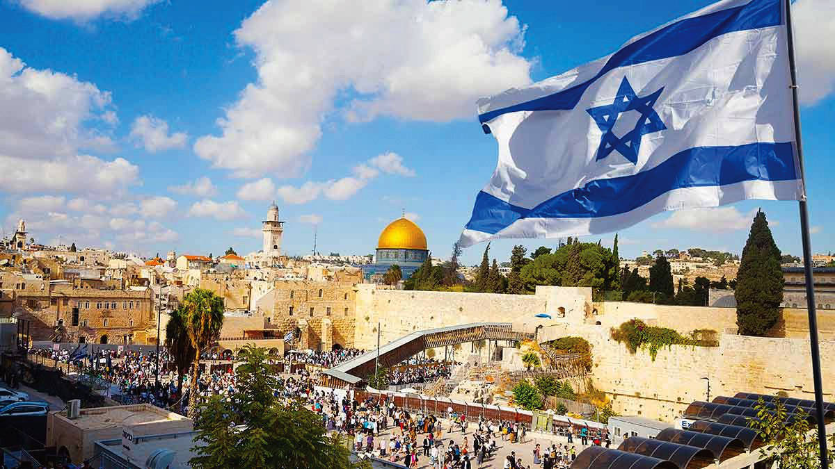 Israel flag with Kotel Wall in background