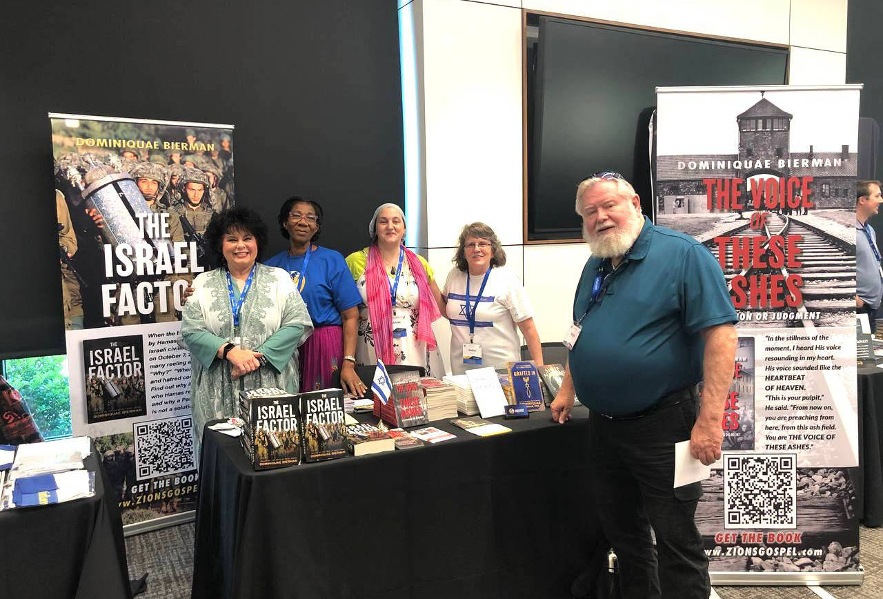 People next to a table full of books