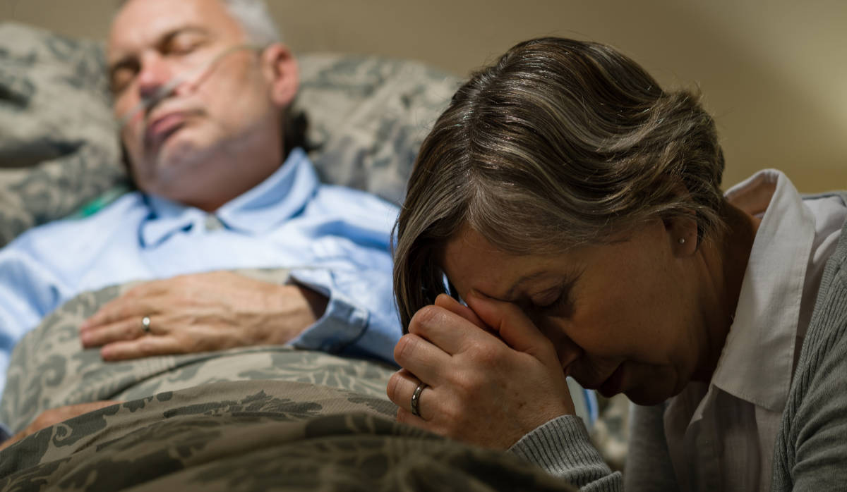 Wife praying for a sick husband