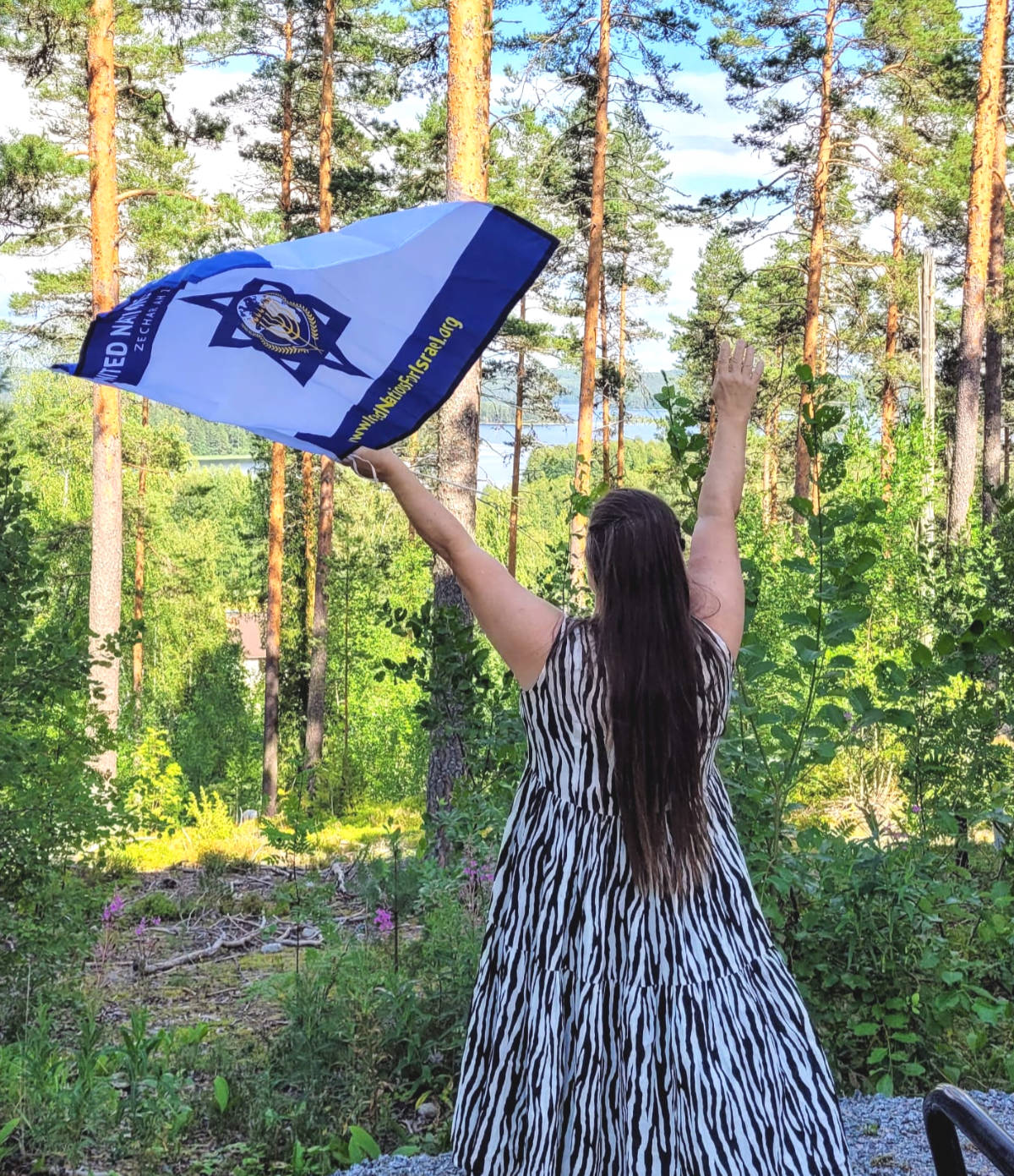 Woman with UNIFY flag in a forest