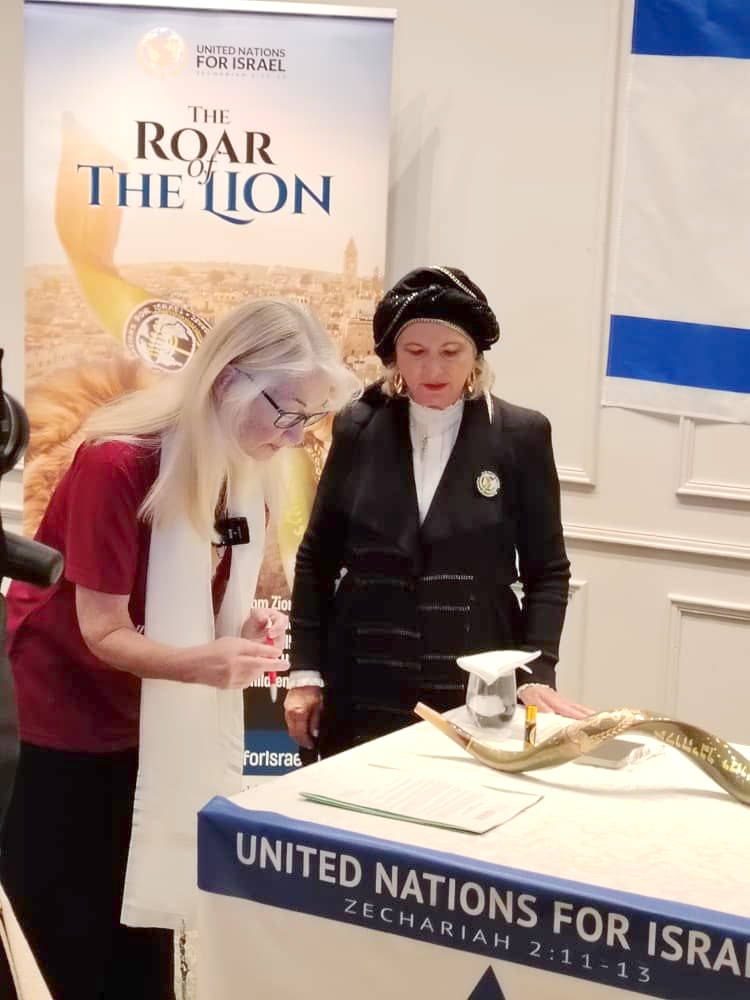 Archbishop Dominiquae Bierman watching a woman reading document