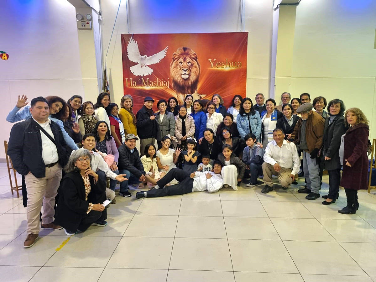 People from Peru in front of Yeshua banner