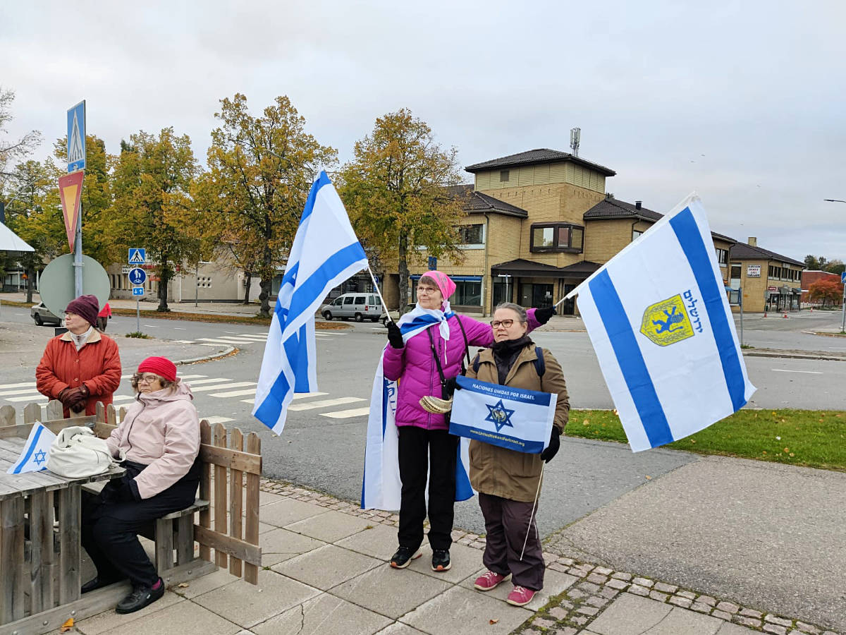 Women from Finland holding Israel and UNIFY flags