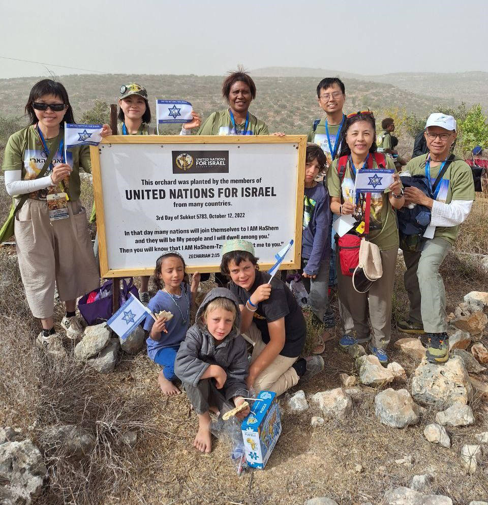 Israel Tour participants next to a field with planted trees