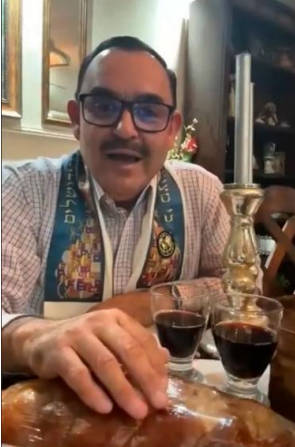 A man with two small glasses of wine