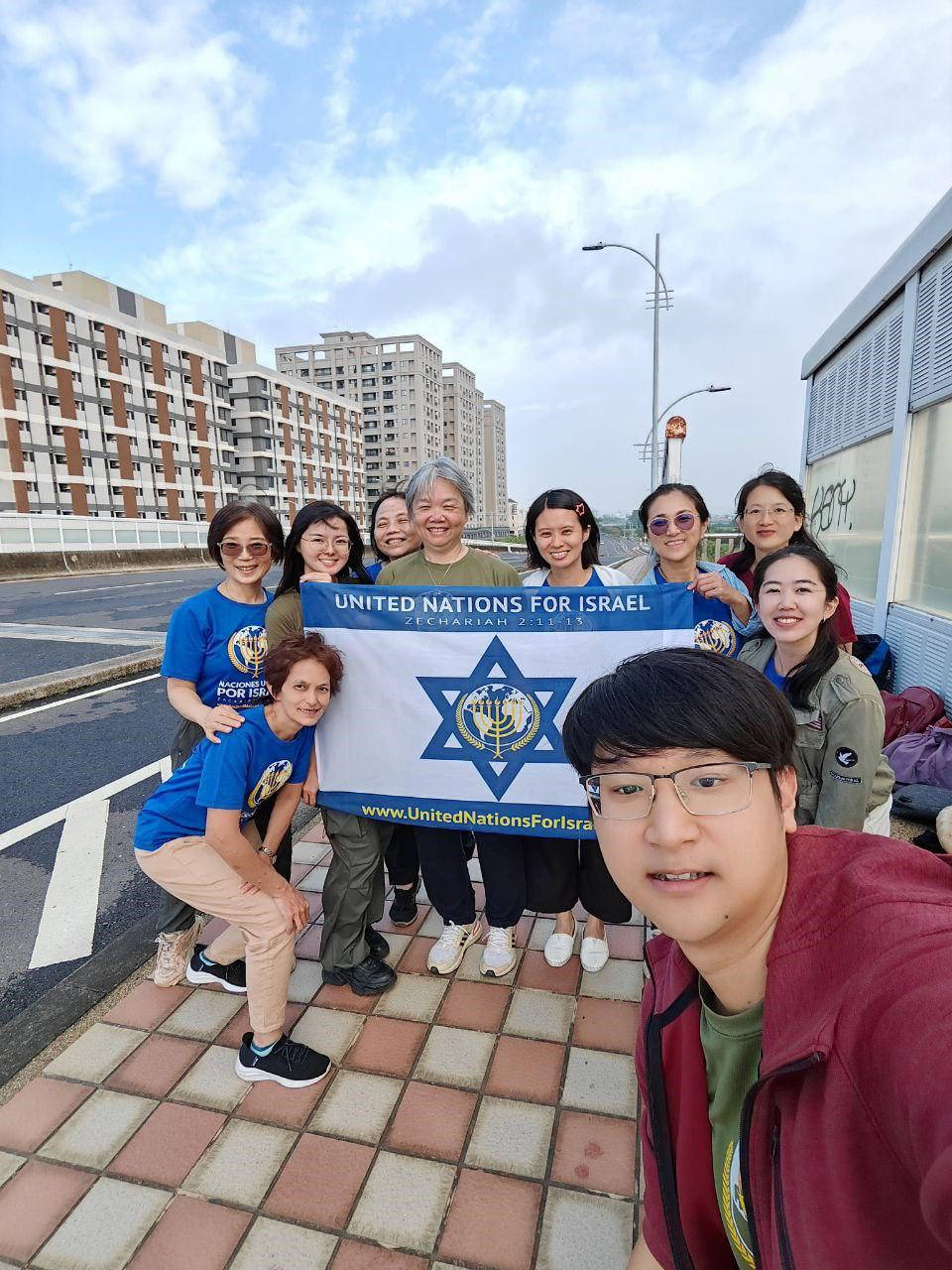 Group of asian people holding UNIFY flag