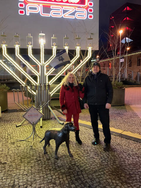 Couple in front of menorah